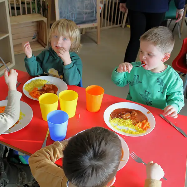 Happy children eating at Home From Home Nursery.